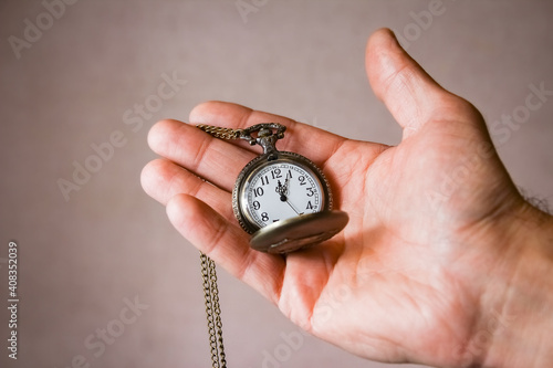 a pocket watch in the hands of a man