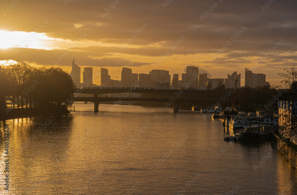 Paris, France - 01 17 2021: View of the Seine and The Defense district at sunset from Clichy Bridge