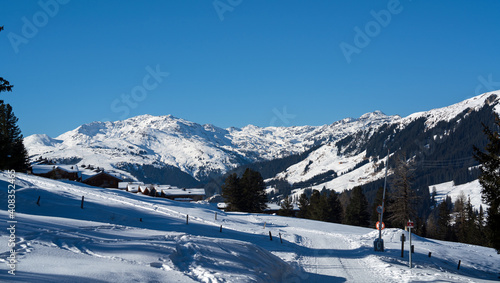 Fototapeta Naklejka Na Ścianę i Meble -  snow wandering in a village on the mountains on a beautiful sunny winter day