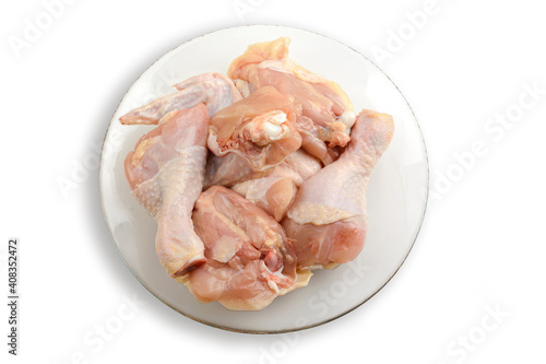 Raw chicken meat on a plate. Isolated on a white background.The view from the top. Healthy eating