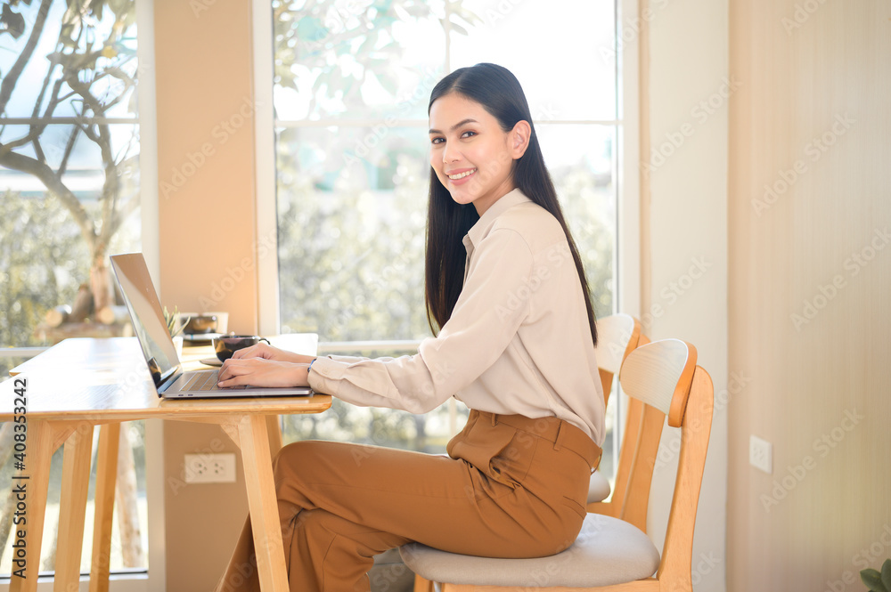Young business woman working with her laptop in coffee shop Young business woman working with her laptop in coffee shop