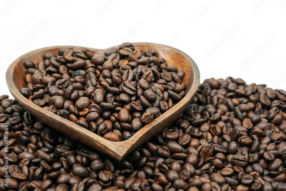 Fototapeta premium Coffee beans in wooden bowl on white background for valentines day concept.