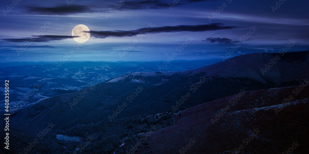 hills and meadows under the blue sky at night. hills and meadows under the blue sky at night. mountain landscape in late summer in full moon light. beautiful scenery in august hills and meadows under the blue sky at night. hills and meadows under the blue sky at night. mountain landscape in late summer in full moon light. beautiful scenery in august