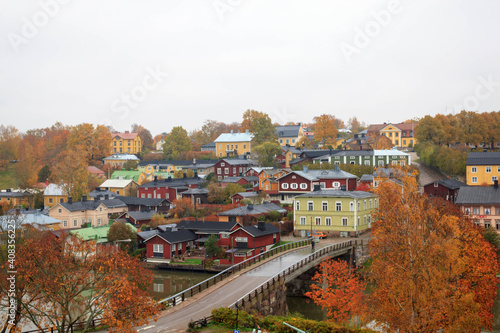 Beautiful panorama of the embankment rivers and urban architecture, bridge, colored houses, roofs and churches of the city of Porvoo in finland
