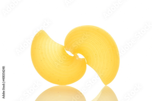 Bright yellow uncooked pasta, close-up, isolated on white.