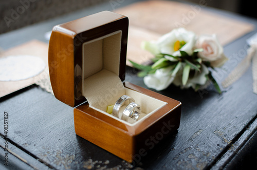 wedding rings in a box with flowers