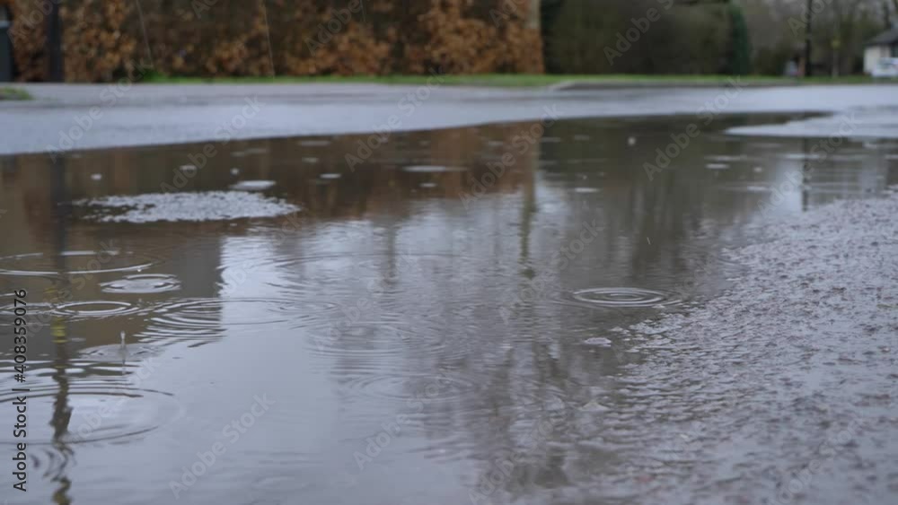 Close Up Shot of Rain Droplets Landing In Puddle Close Up Shot of Rain Droplets Landing In Puddle