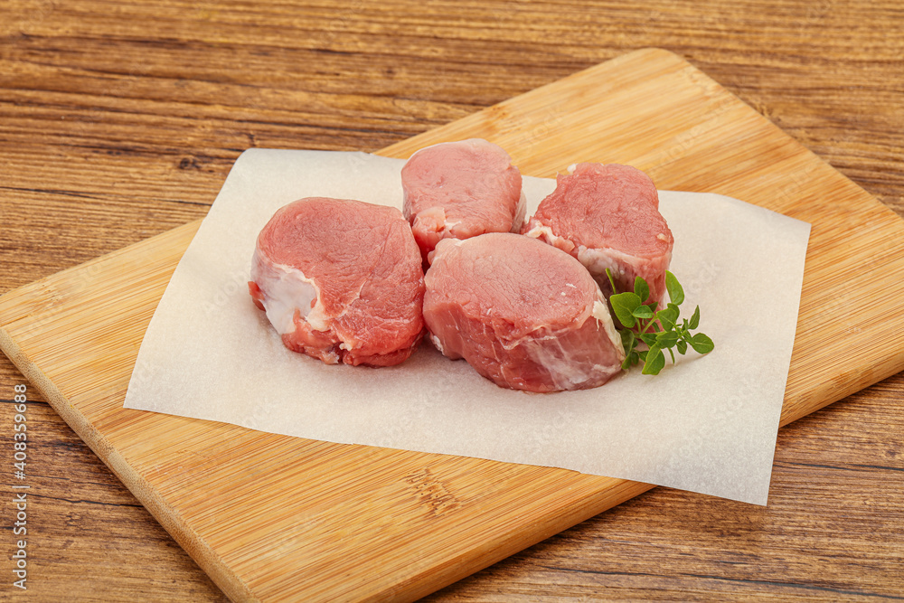 Raw pork medallion served rosemary Raw pork medallion served rosemary