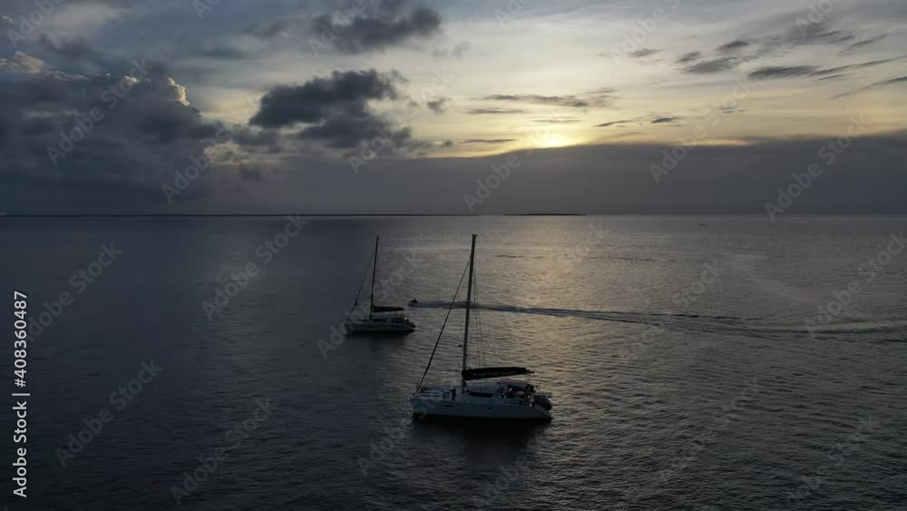 Boat sailing on the Indian Ocean.Fishermen's wooden dhow sailing at sunset in Zanzibar. Zanzibar is a Tanzanian archipelago off the coast of East Africa Boat sailing on the Indian Ocean.Fishermen's wooden dhow sailing at sunset in Zanzibar. Zanzibar is a Tanzanian archipelago off the coast of East Africa