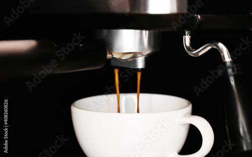 Close up of coffee pouring into the cup. Coffee machine.