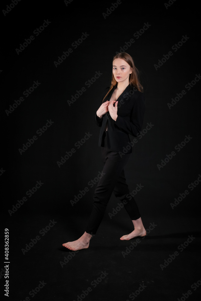 image of a model girl in a black suit on a black background