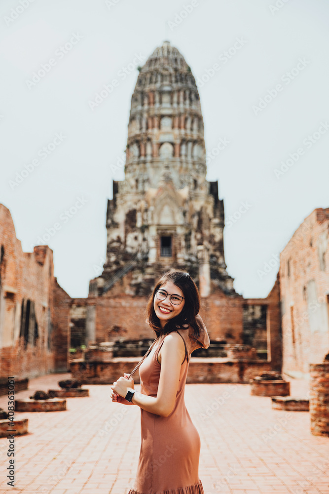 Tourist woman in brown dress at Wat Ratchaburana Temple, Ayutthaya, Thailand
