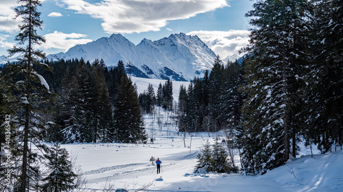 nordic skiing in the snow capped mountain with view to the alps