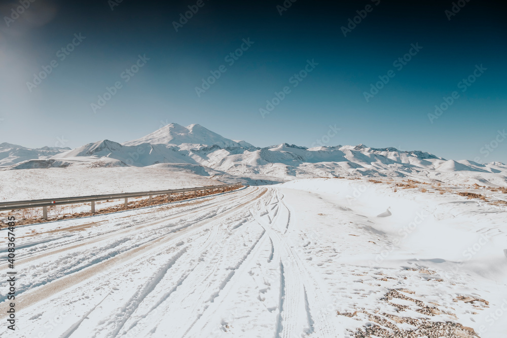 Snowy peaks of Mount Elbrus. Mountains of the Caucasus. Mountain road landscape. 
