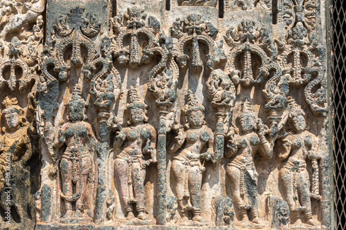 Lakkundi, Karnataka, India - November 6, 2013: Kasivisvesvara Temple. Damaged row of female figures as plinth at bottom of entrance frame.  photo