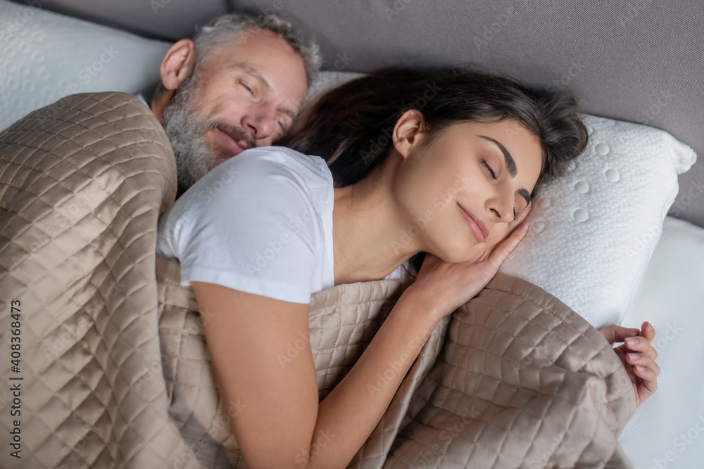 Man and woman sleeping in the bed together Man and woman sleeping in the bed together
