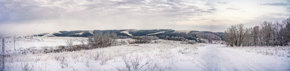 winter panorama - a landscape of snow fields, forests and roads on the horizon against the sky winter panorama - a landscape of snow fields, forests and roads on the horizon against the sky