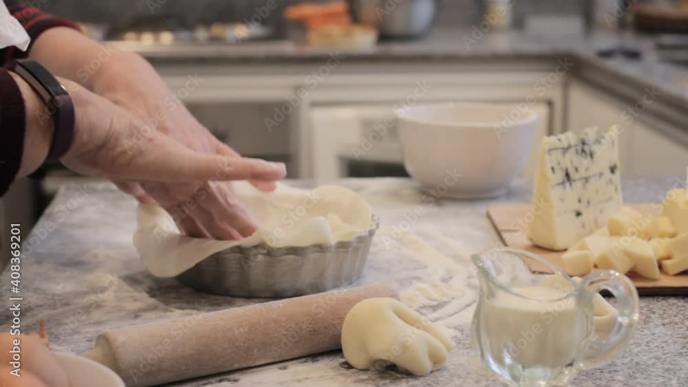 Crop cook preparing crust for quiche in kitchen at home Crop cook preparing crust for quiche in kitchen at home