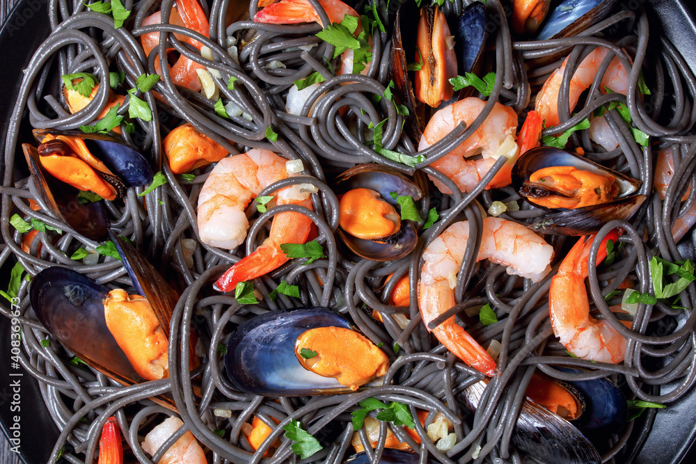 Squid ink pasta with mussels and shrimps, top view