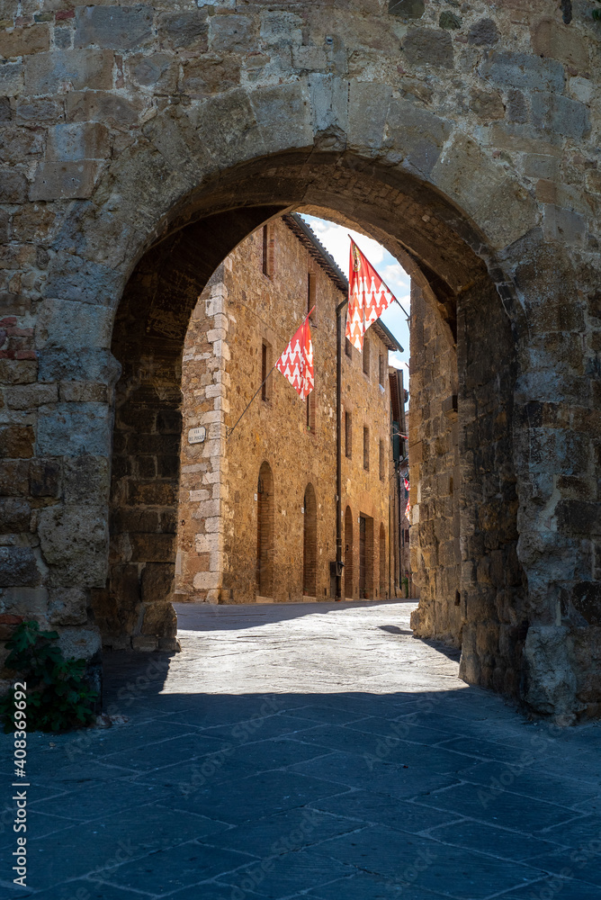 San Quirico d' Orcia, Tuscany, Italy - June 19, 2017: Flags of San Quirico d' Orcia's buildings