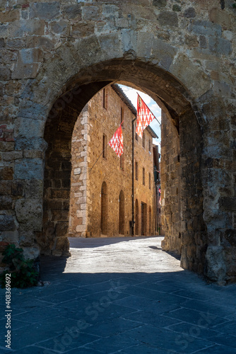 San Quirico d' Orcia, Tuscany, Italy - June 19, 2017: Flags of San Quirico d' Orcia's buildings © Panos