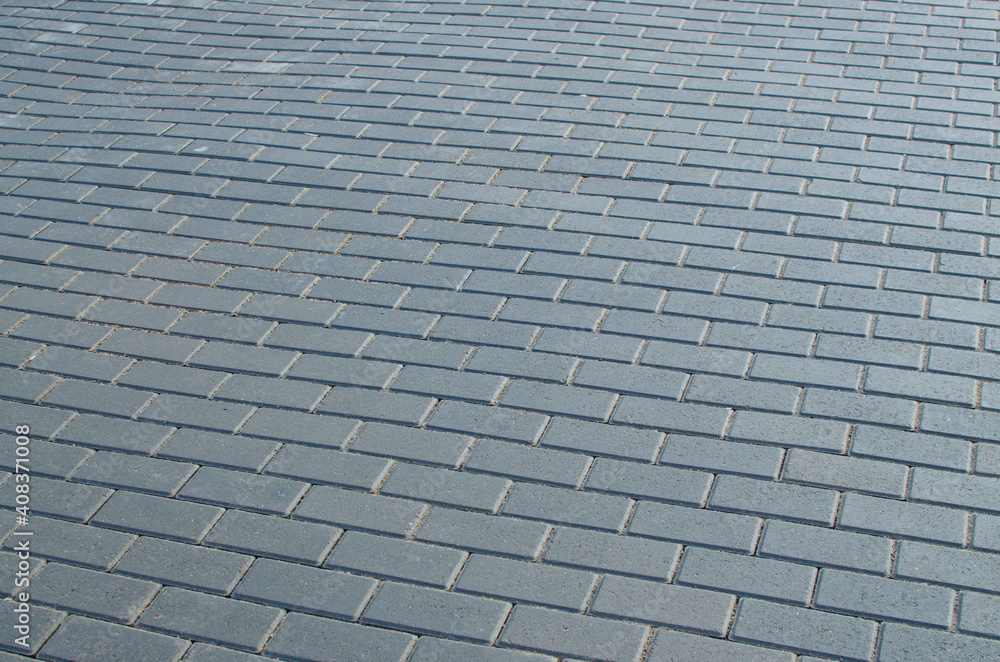 The paving stones on the road are laid in even rows.