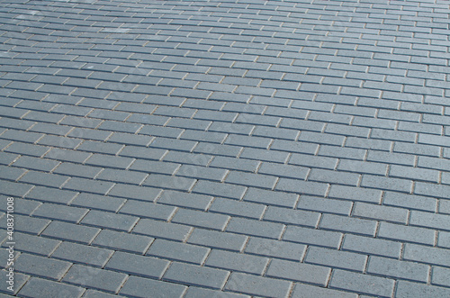 Obraz na płótnie The paving stones on the road are laid in even rows. w salonie