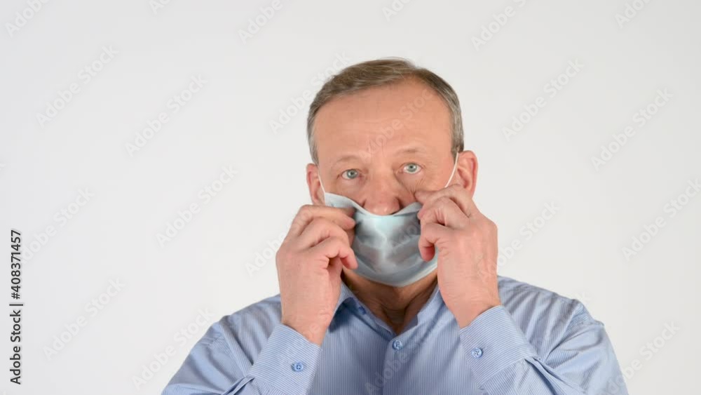 Portrait of an elderly man wearing a medical mask isolated on a studio background. covid concept health and safety. Health care and medical. Portrait of an elderly man wearing a medical mask isolated on a studio background. covid concept health and safety. Health care and medical.