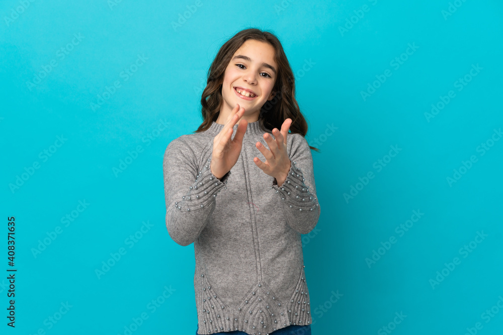 Little caucasian girl isolated on blue background applauding after presentation in a conference Little caucasian girl isolated on blue background applauding after presentation in a conference