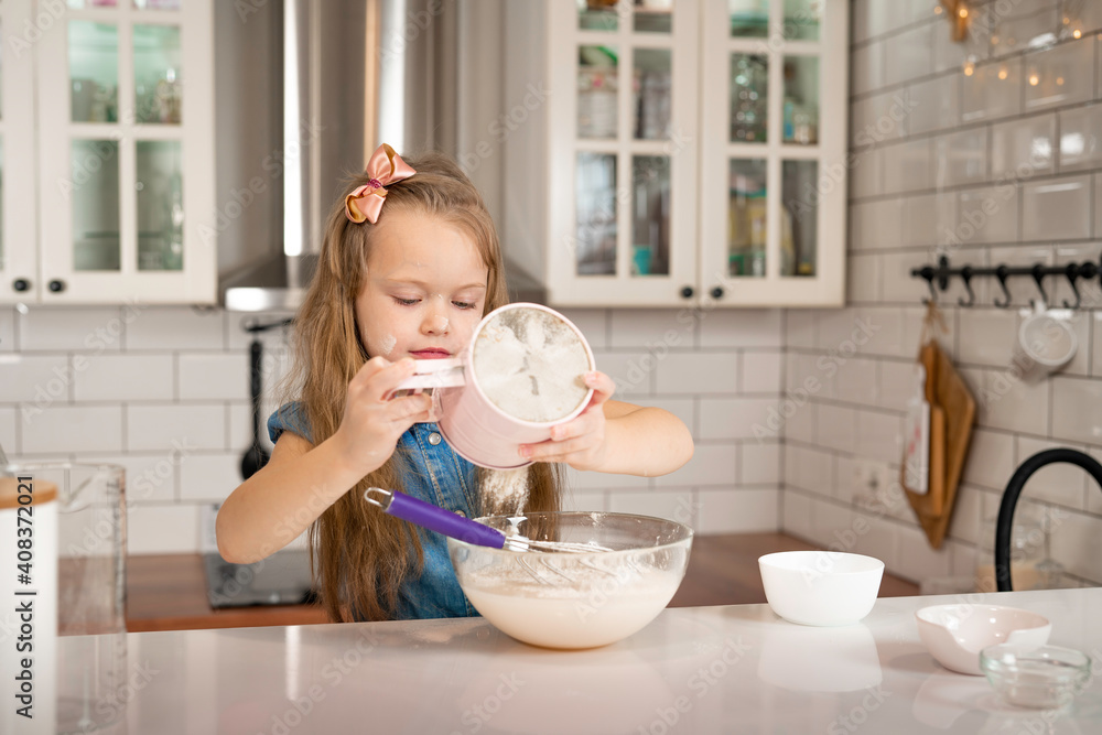 little cute girl with blond hair preparing pancakes in the kitchen on her own little cute girl with blond hair preparing pancakes in the kitchen on her own