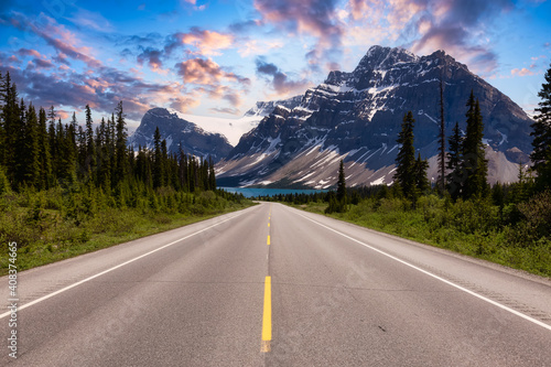 Scenic road in the Canadian Rockies. Dramatic Colorful Sunset Sky Art Render. Taken in Icefields Parkway, Banff National Park, Alberta, Canada. Panorama Background