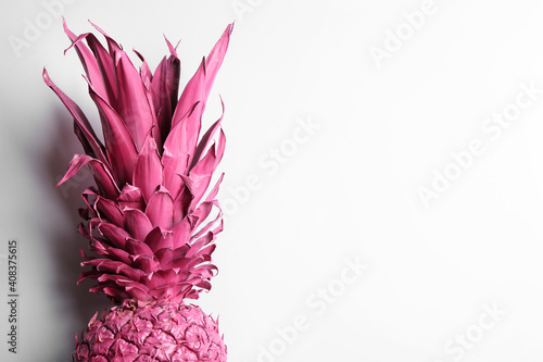 Painted pink pineapple on white background  top view. Creative concept
