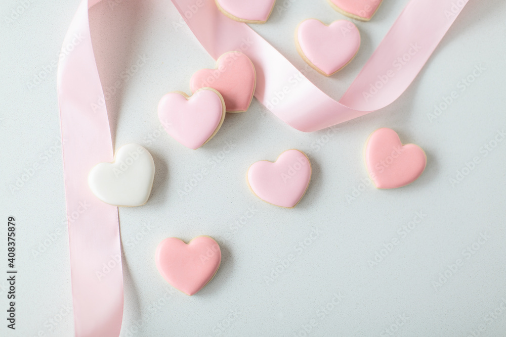pink heart sugar cookies on white background, with pink ribbon pink heart sugar cookies on white background, with pink ribbon