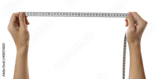 Woman holding measuring tape on white background, closeup