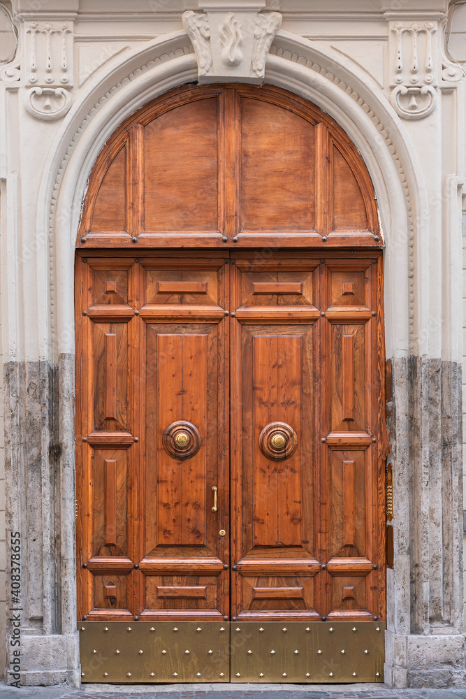 wooden door with a beautiful decorative finish in the historical part of Rome