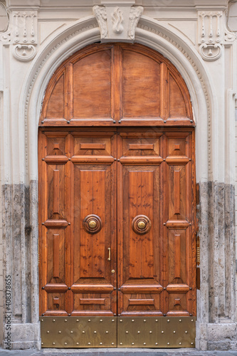 wooden door with a beautiful decorative finish in the historical part of Rome