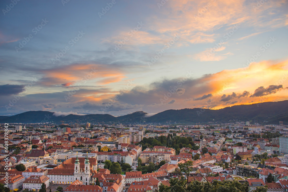 Cityscape of Graz with Mariahilfer church and historic and modern buildings of Graz, Styria region, Austria, at sunset. Dramatic sky, panoramic view