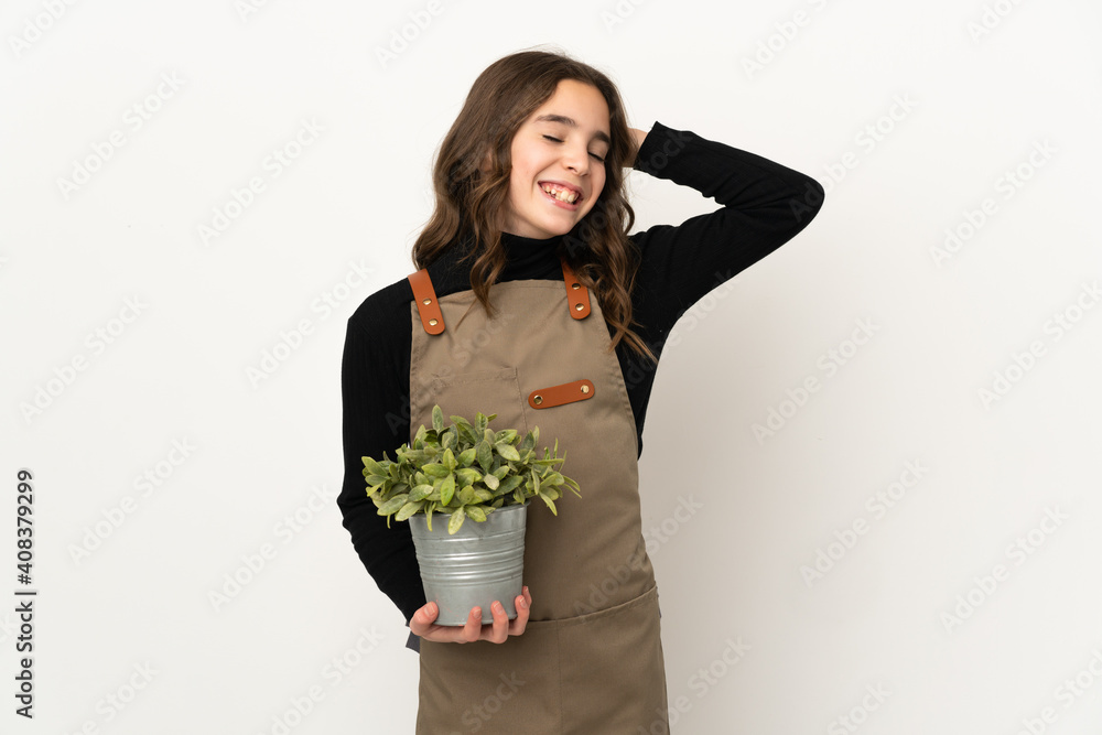 Little girl holding a plant isolated on white background smiling a lot Little girl holding a plant isolated on white background smiling a lot