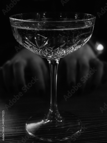 Hands reach for a glass of champagne black and white photo.