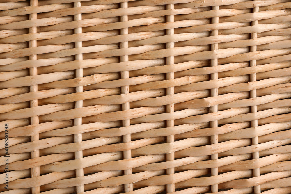 Handmade wicker basket made of natural material as background, closeup view Handmade wicker basket made of natural material as background, closeup view