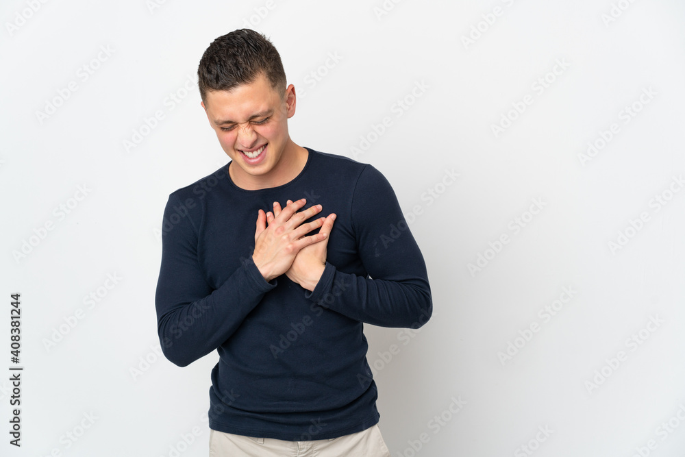 Young caucasian man isolated on white background having a pain in the heart Young caucasian man isolated on white background having a pain in the heart