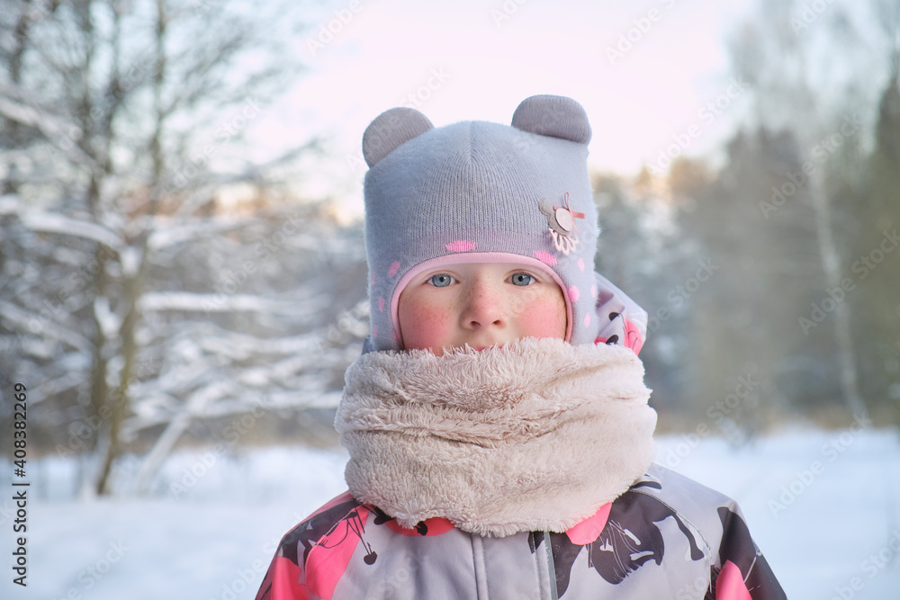Closeup portrait of cute youg girl in winter forest. Warm clothes for the winter season. Closeup portrait of cute youg girl in winter forest. Warm clothes for the winter season.