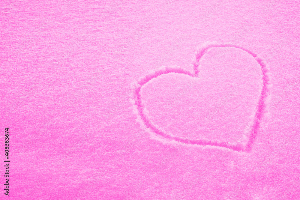 Drawing of a heart in the snow on a pink background. The concept of Valentine's Day. A symbol of love. Texture. A postcard, a place for the text. Copy space