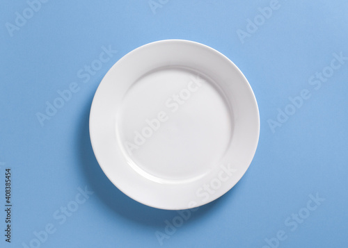 White dinner plate on pastel blue