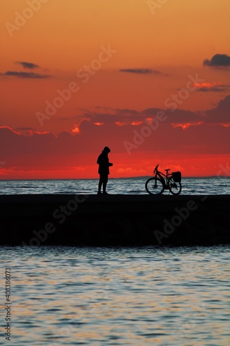 silhouette of a person riding a bike