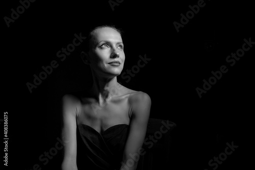 portrait of a woman in black dress with naked shoulders. Sensual portait of young 30 years old woman. black and  white