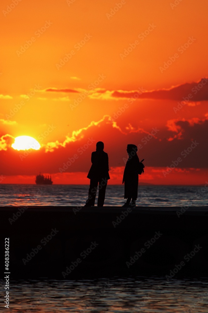 silhouette of friends on the beach
