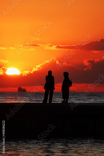 silhouette of friends on the beach