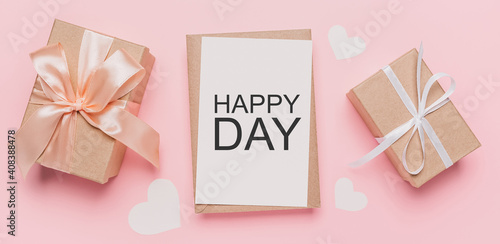 Gifts with note letter on isolated pink background, love and valentine concept with text happy day