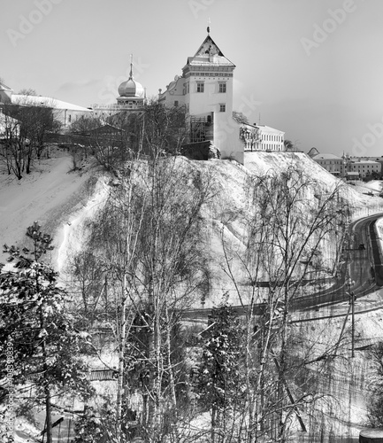 Sights and views of Grodno. Belarus. View of the restored building of the Old Castle on a high snow-covered hill. Black and white version. © Volha